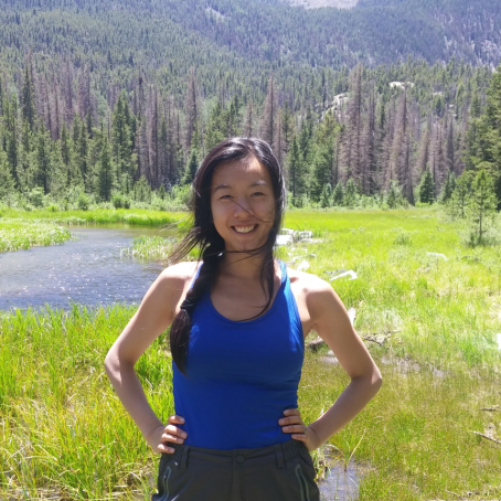 Photo of Melissa Chen outside in front of trees. 